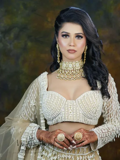 The complete engagement look, showcasing how the makeup complements the elegant white lehenga. The hair and makeup work together to create a cohesive and breathtaking vision.