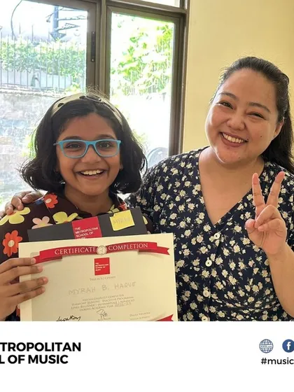 We celebrate every milestone on your musical journey. Here, a proud student receives her certificate for successfully completing our Western Vocals beginner program, a testament to her hard work and our effective teaching.