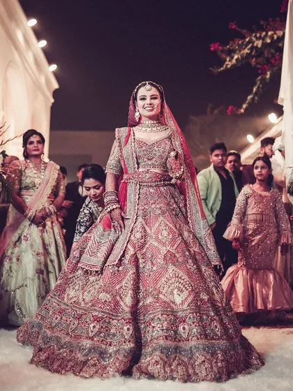 The bride's grand entrance, looking radiant in her stunning red lehenga.