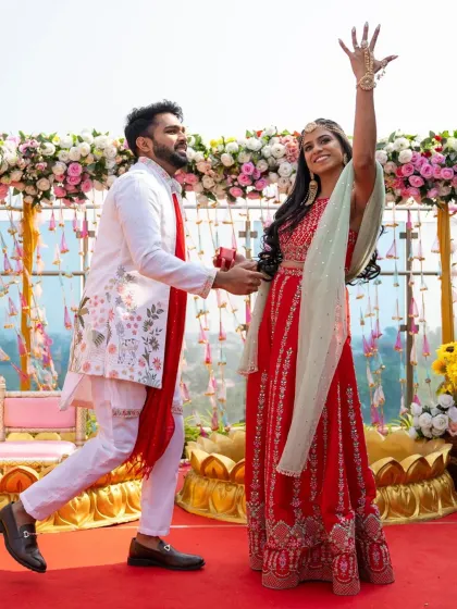 A joyful, dance-like pose from the couple at their Mehendi. Their energy is contagious.