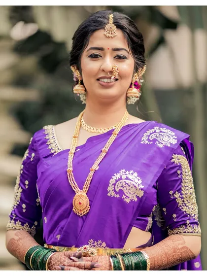 Akshaya in a striking purple Paithani. Her makeup was kept muted to let the unique saree color and intricate jewelry shine, creating a look to remember.