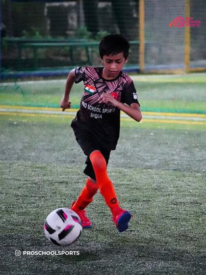 A young player dribbles with determination, showing the spirit we love to see in training.