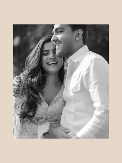 A beautiful black and white photo capturing a moment of pure, uninhibited laughter. This timeless shot focuses entirely on the joy and connection between the couple.