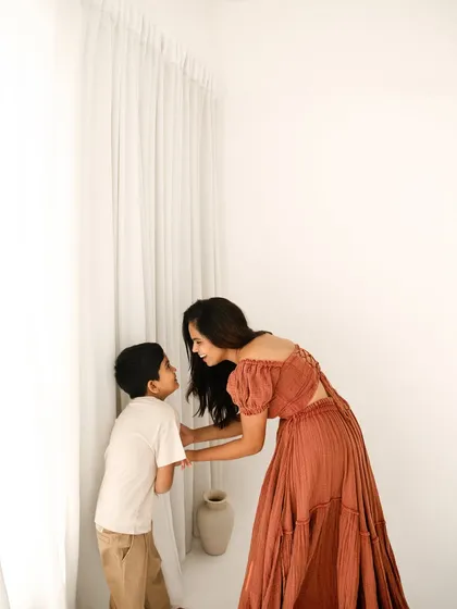 A quiet conversation between mother and son. The high-key, minimalist setting puts all the focus on their interaction and loving bond.