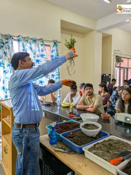 An instructor demonstrates the importance of a healthy root system to an attentive class of botany students. This is the kind of practical knowledge we emphasize in our workshops.