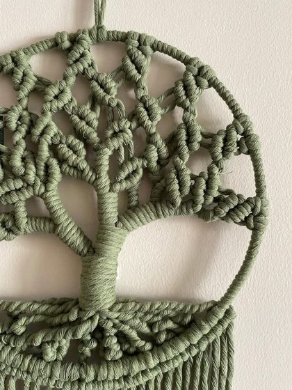 A detailed close-up of the trunk and branches on the green Tree of Life. So much love and patience goes into each knot.