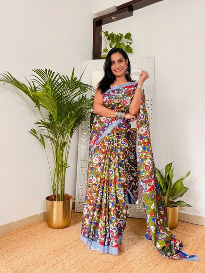 This multi-colored Kalamkari saree is a piece of art. The vibrant colors and intricate design make it a standout piece, even though it's a comfortable cotton saree.
