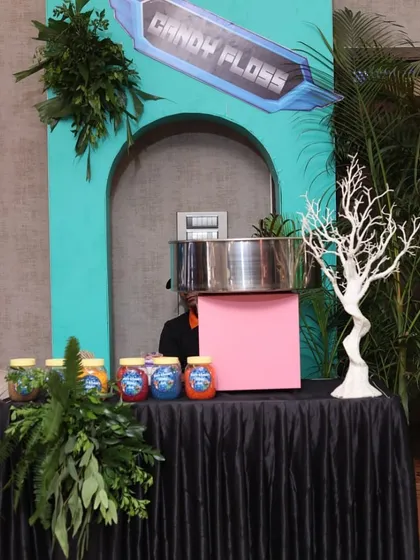 Our candy floss station set up for a theme birthday. The stall is decorated with lush greenery to blend seamlessly with the party's decor.