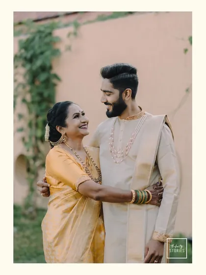 A heartwarming portrait of a groom and his mother sharing a loving gaze. This candid moment captures the special bond between them on the wedding day.