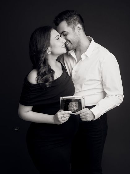 A creative black and white shot incorporating their baby's sonogram. It's a beautiful way to include the little one in the maternity photos.
