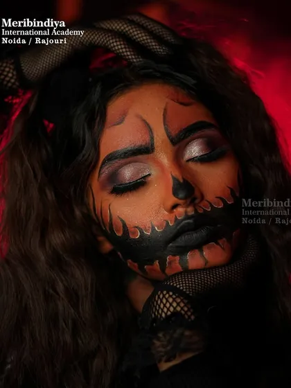 Lighting can transform a look. The red backlight adds a sinister vibe to this pumpkin makeup, a technique we explore in our photoshoots.