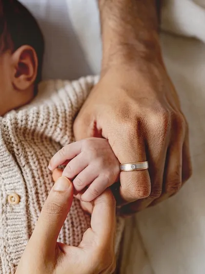 Sometimes the most powerful photos are in the smallest details. A newborn's hand wrapped around their parent's finger is a beautiful symbol of connection and a memory you'll want to hold onto forever.