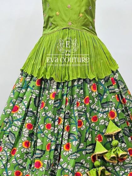 A close-up of a green Kalamkari lehenga with a beautiful floral and fruit print.