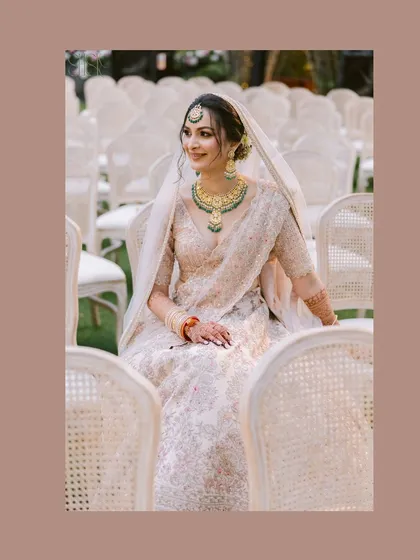 A serene portrait of the bride, Sachi, seated amidst the empty ceremony chairs, taking a quiet moment before the guests arrive.