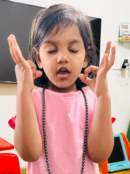 My daughter showing us her meditation pose. It's important to acknowledge and praise good behavior, not just correct the bad. This photo is a reminder to celebrate our children's efforts and positive actions, which builds their confidence and emotional intelligence.