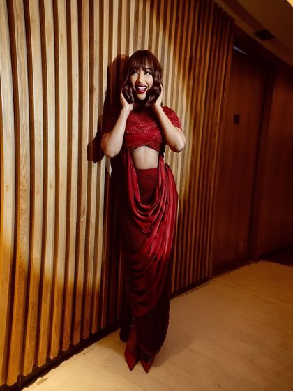 A striking crimson cowl-drape two-piece set that blends fluid elegance with confident structure. Crimson is a color of passion and presence.