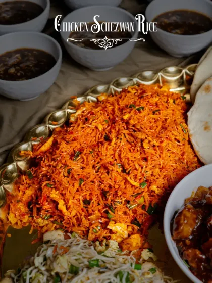 A mountain of fiery Chicken Schezwan Rice, the centerpiece of our Thaal-E-Cheen, promising a burst of flavor in every spoonful.