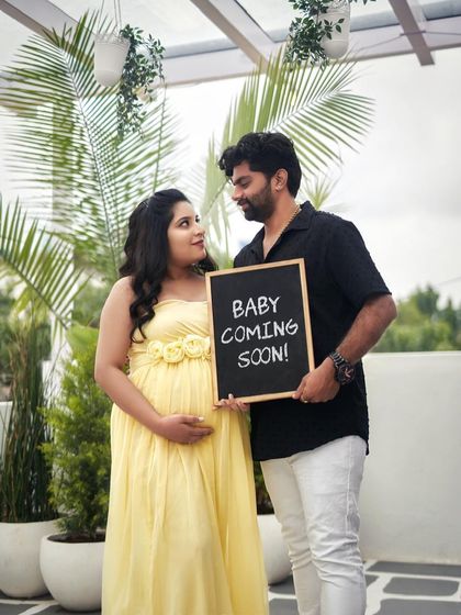 A fun and happy announcement. The "Baby Coming Soon" sign is a great prop to include in your couple's maternity shoot.