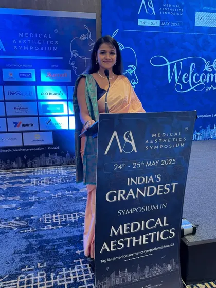 At the lectern, ready to begin the proceedings for the Medical Aesthetics Symposium.