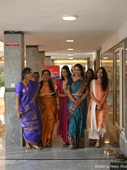A happy moment with friends and family. The bride stands out in her beautiful teal Kanjeevaram, her hair and makeup perfectly styled for the occasion.
