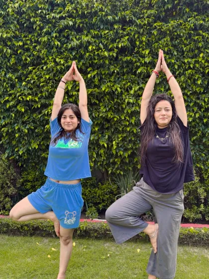 Finding our balance together with a tree pose in the park.