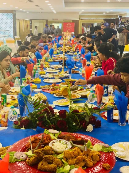 A snapshot of a grand lunch wedding, capturing the vibrant energy of a full house. The long, beautifully decorated tables are laden with our finest dishes, showing our capacity to serve large gatherings without compromising on quality or presentation.