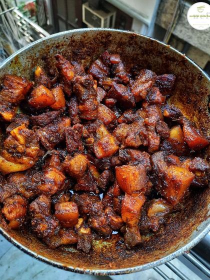 A pan of my spicy pork stir fry, sizzling and ready to be served.