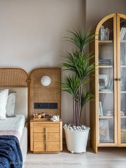 The master bedroom is a breezy, light-filled retreat. The rattan headboard and light wood tones continue the home's organic, Japandi-inspired theme, making it a place to truly unwind.