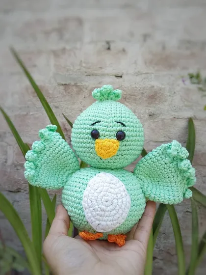 This is Koda, a sweet little bird amigurumi I made. I used a lovely mint green cotton yarn for his body and gave him little wings that are ready for a hug. All the features are securely attached, making him a durable little friend.