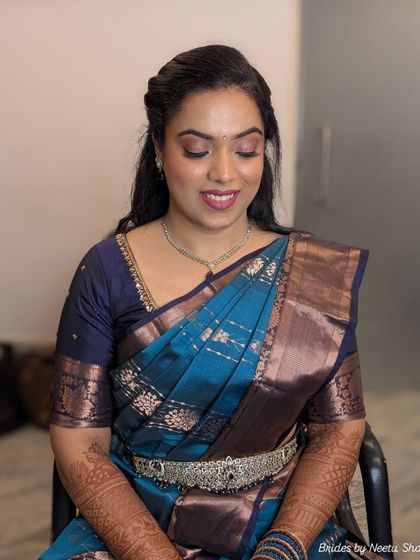 A serene close-up of the bride. The soft pink eyeshadow and perfectly draped saree showcase a look of understated elegance.