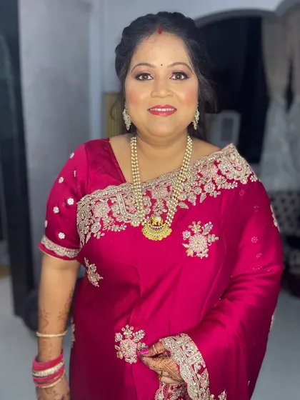 My client looking beautiful and confident in her embroidered pink saree. The makeup enhances her natural glow.