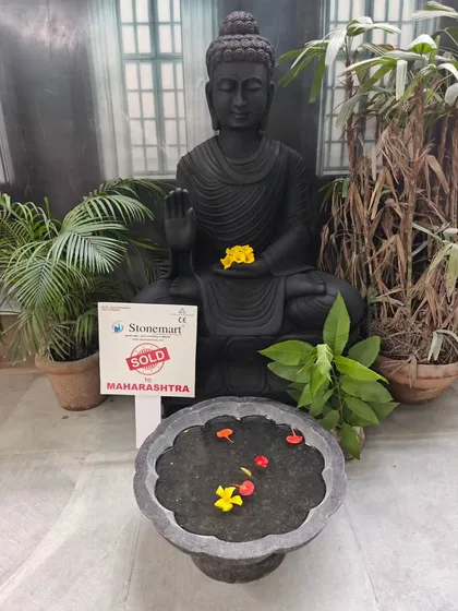 The deep black marble of this 4-foot Buddha statue provides a beautiful contrast to the colorful flowers in the accompanying uruli. It is a centerpiece that exudes tranquility.