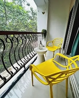 This is my favorite morning spot. The main balcony, with its bright yellow chairs, overlooks the surrounding greenery. It's the perfect place to enjoy a cup of chai and soak in the peaceful Goan atmosphere before starting your day.