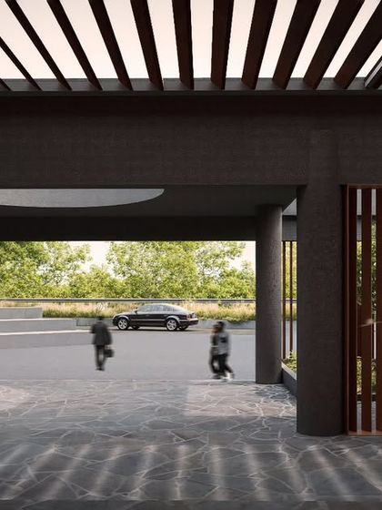 The play of light and shadow is a key element in the design of the SMGR Memorial. Here, a slatted pergola casts linear patterns across the stone floor at the entrance, creating a powerful and contemplative atmosphere.