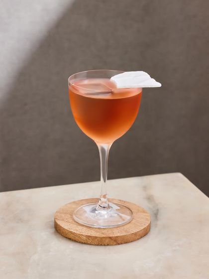 The Slow Love cocktail, designed for romantic Saturday nights. This elegant drink combines vodka with the floral notes of roselle tea and a house-made guava shrub.