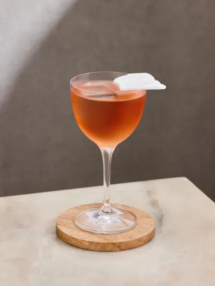 The Slow Love cocktail, designed for romantic Saturday nights. This elegant drink combines vodka with the floral notes of roselle tea and a house-made guava shrub.