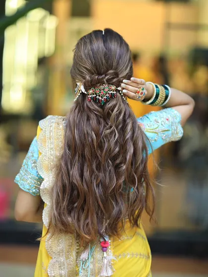 Another view of the wavy half updo. This hairstyle is perfect for a destination wedding or a relaxed, outdoor ceremony.