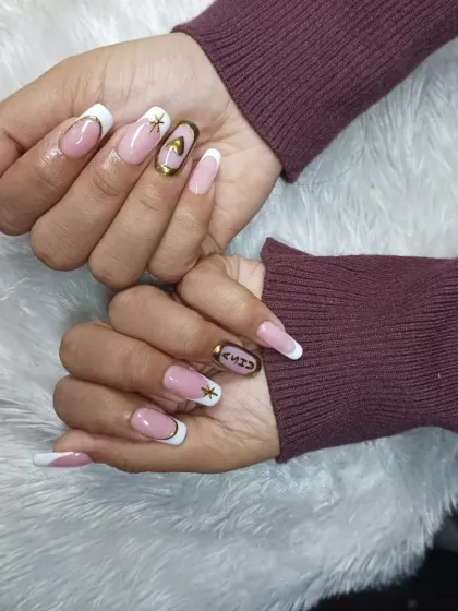 A still image of the custom French manicure with gold chrome accents and celestial designs.
