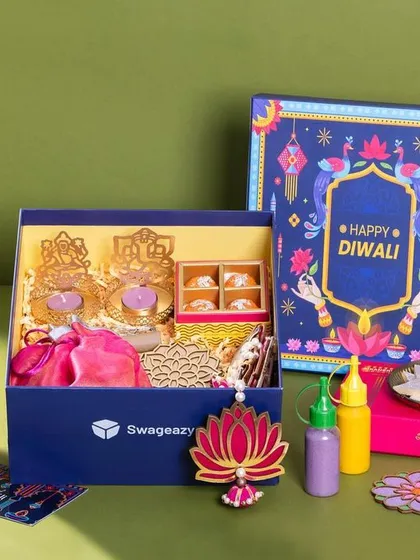 A festive hamper shoot for Swageasy, capturing a colorful Diwali gift box. The flat lay composition is carefully arranged to display all the contents, from sweets and nuts to decor items, making it ideal for seasonal marketing campaigns.