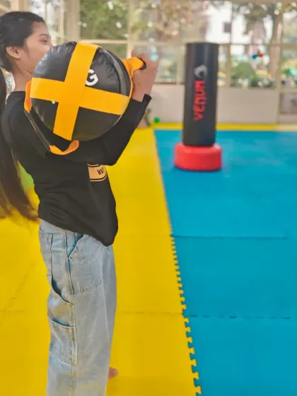 A student prepares for a drill with a striking shield. This type of training helps develop power and impact in a safe, controlled manner.
