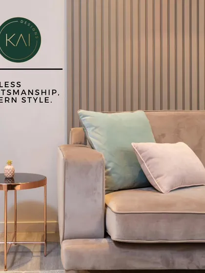 A close-up of a modern living room setting, featuring a beige sofa with soft accent pillows and a copper-toned side table. This image highlights our skill in creating timeless, modern spaces through careful selection of furniture and accessories.
