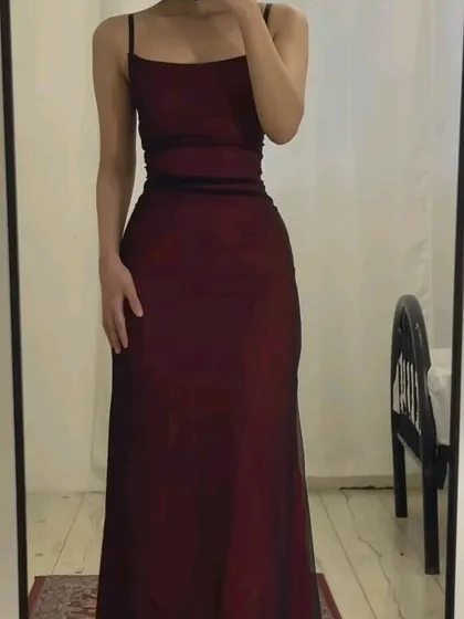A client's mirror selfie showcasing the simple elegance of this maroon spaghetti strap gown. The clean lines and perfect fit are central to my design philosophy.