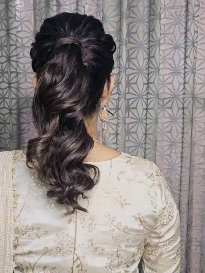 A chic and modern ponytail with soft waves for Shriya. This hairstyle is perfect for a reception or sangeet.
