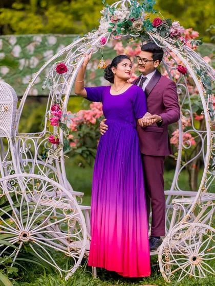 A sweet couple poses by the Cinderella carriage, a classic choice for a romantic pre-wedding shoot.
