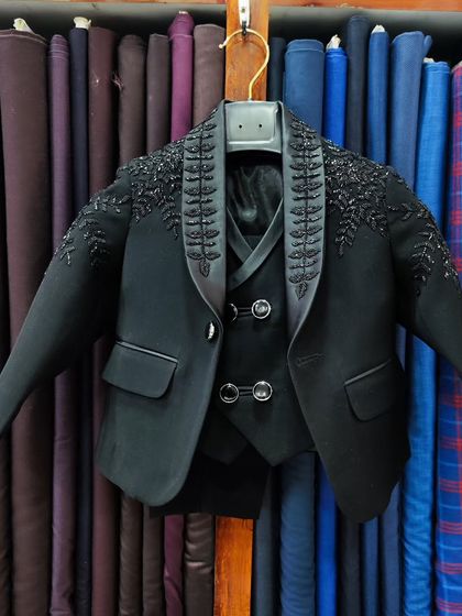 I also create matching outfits for fathers and sons. This is a miniature version of a groom's wedding suit, complete with intricate hand embroidery, ensuring the little one looks just as dapper.