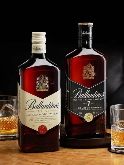 A clean and classic shot of two Ballantine's whiskies. The dark leather background and simple wooden table create a masculine, sophisticated mood that perfectly suits the brand.