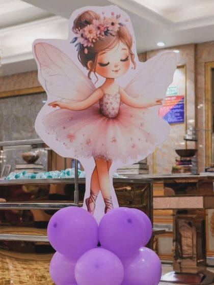 A sweet fairy character cutout adds a charming touch to the party decor. These small details help in making the theme feel complete and magical for the kids.