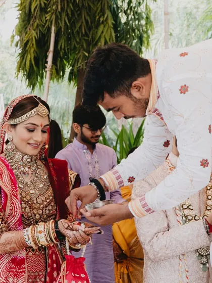 A family member performs a ritual for the bride, a moment of blessing and community.