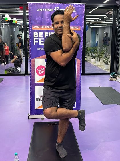 Another member confidently holding the Eagle Pose. We encourage everyone to participate, regardless of their flexibility or experience level.