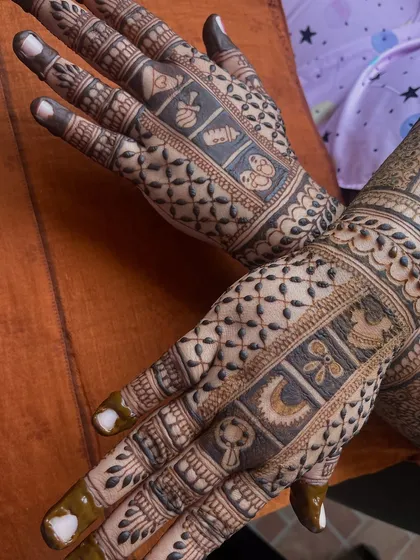 This is the back hand design for a baby shower mehendi. I created small blocks with cute baby themed symbols like a rattle, a crescent moon, and a bow, making for a unique and modern pattern.